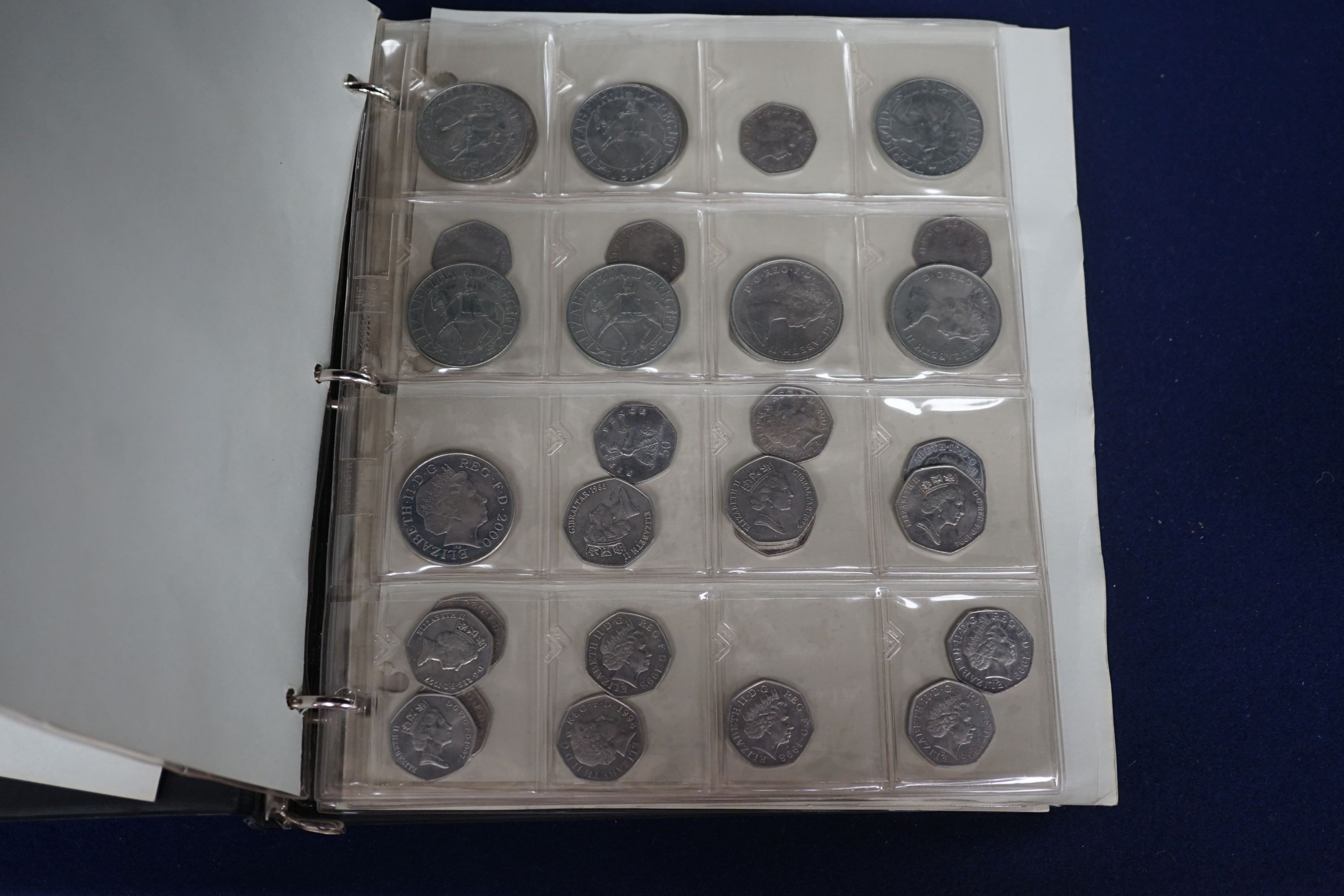 An album of British crowns, halfcrowns, florins and decimal 50 pence and 20 pence coins, including 1819 crown F, etc. and various loose UK coins and banknotes in envelopes